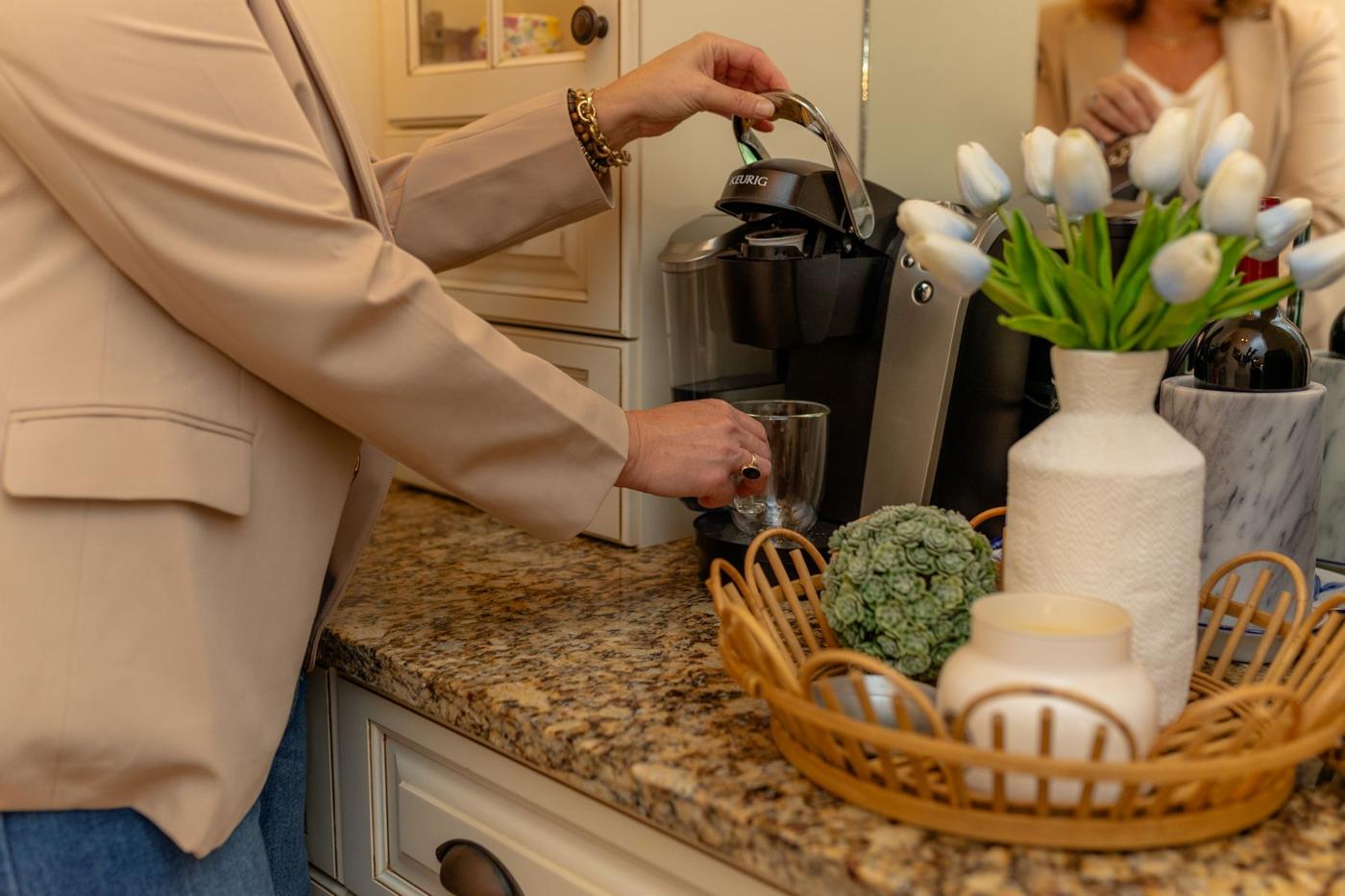 Coffee, tulips and a welcome basket on a kitchen counter